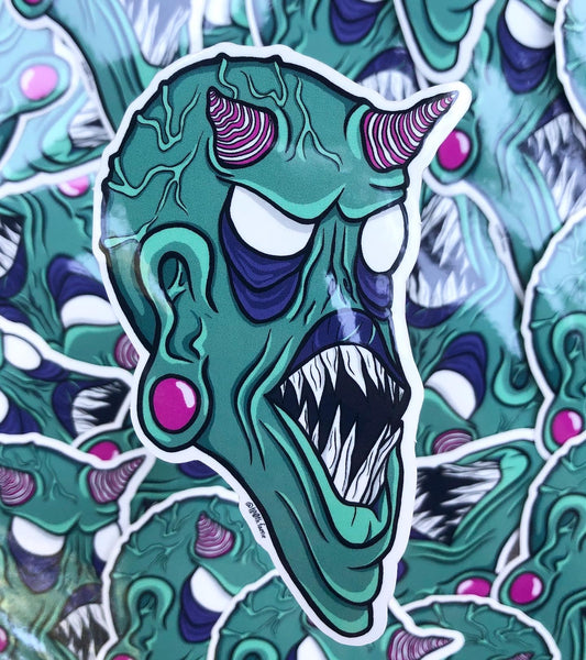 Photo of a vinyl sticker of T00thFaerie Art original green monster artwork. This sticker is perfect for laptops, water bottles, phone cases, planners, and anything else you can think of! It has a glossy texture and measures 2.5” by 4”.