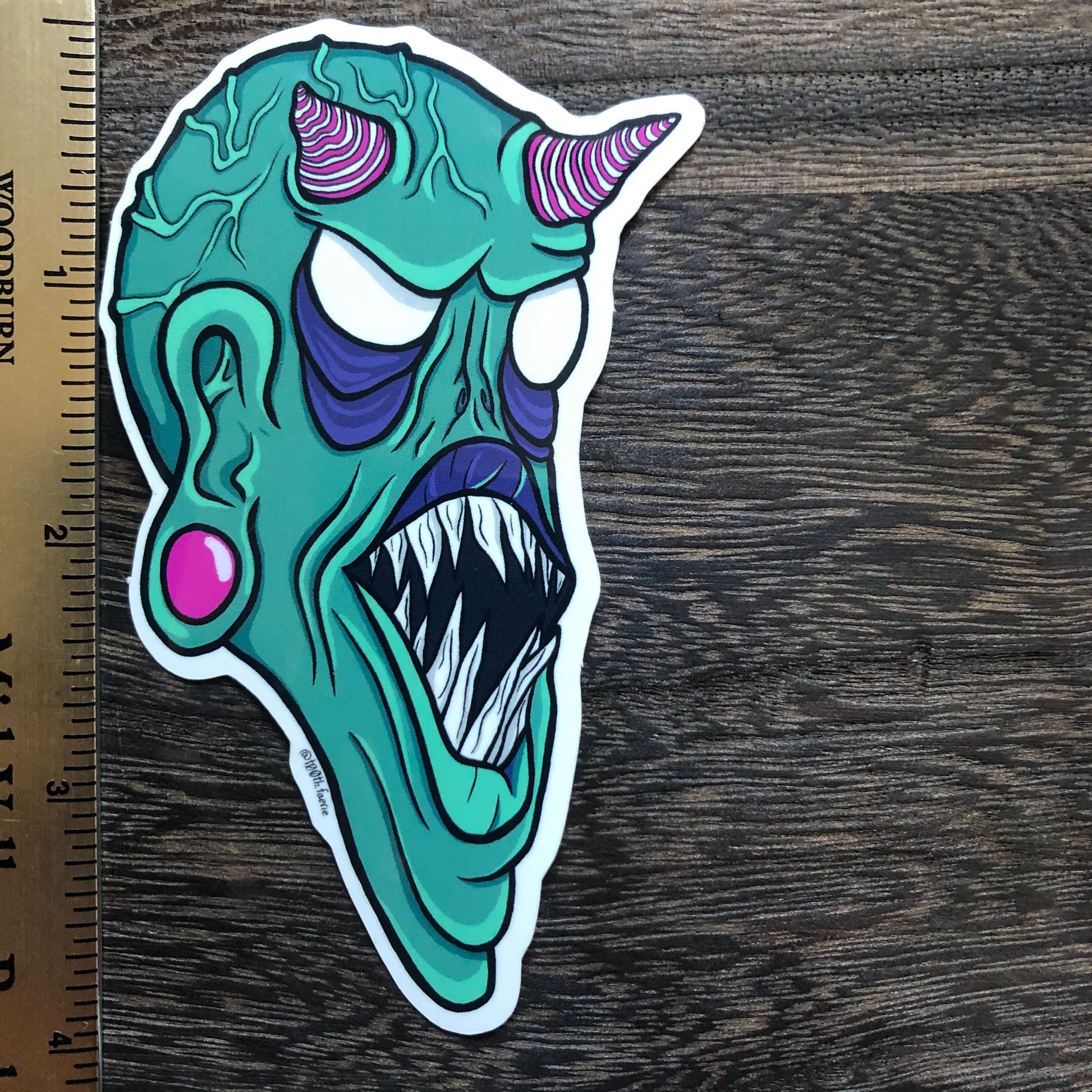 Vinyl sticker of T00thFaerie Art original green monster artwork! This sticker is perfect for laptops, water bottles, phone cases, planners, and anything else you can think of! It has a glossy texture and measures 2.5” by 4”.