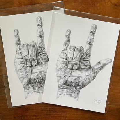 Fine art print of a hand making the "I-Love-You" ASL hand sign. American sign language gift artwork, detailed graphits pencil hand drawing. Deaf or hard-of-hearing language art. photo showing two 5 by 7 prints next to eachother